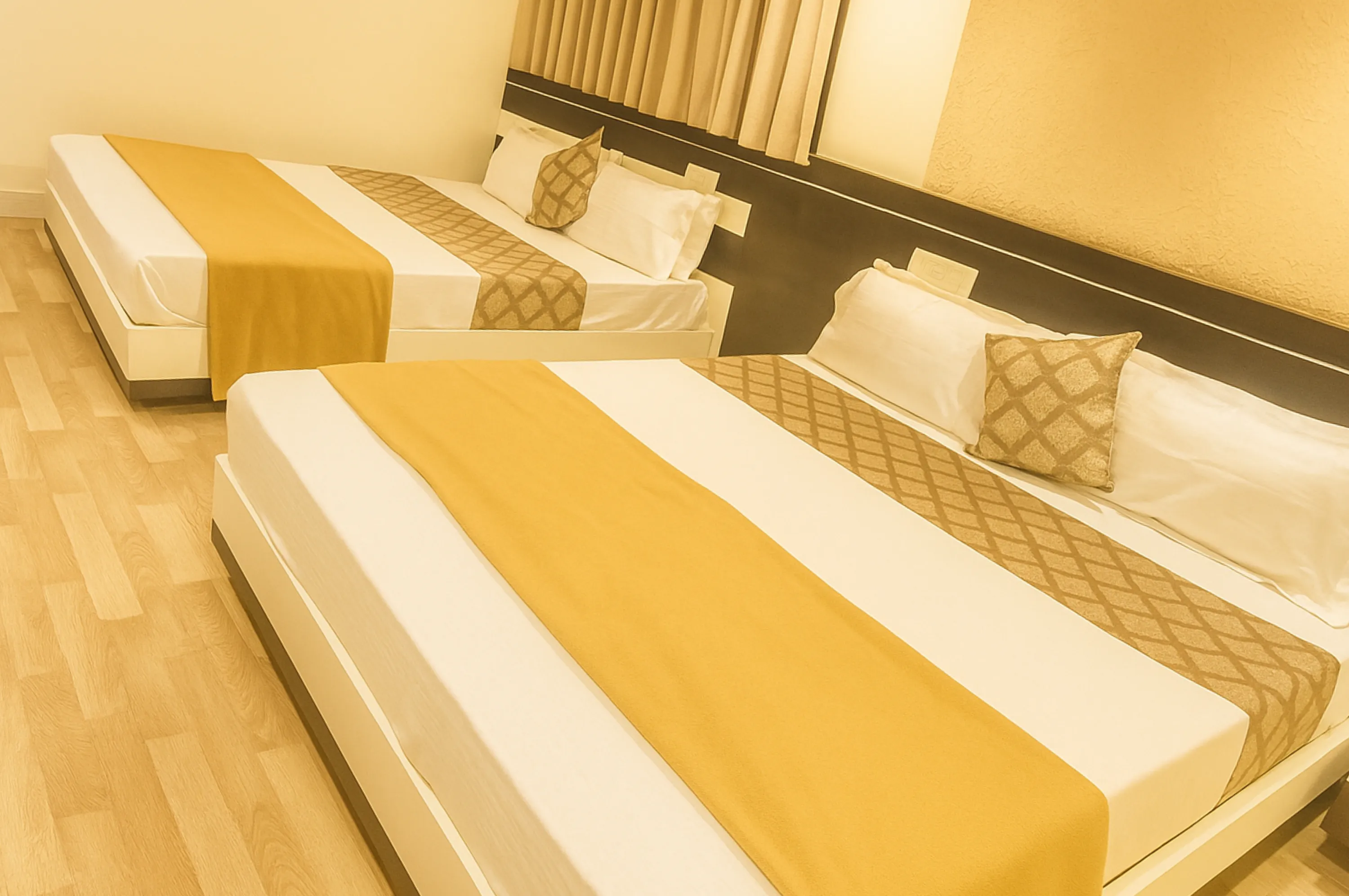 Clean and comfortable four bed AC room at Hotel Vrajbhoomi Somnath for family stay.