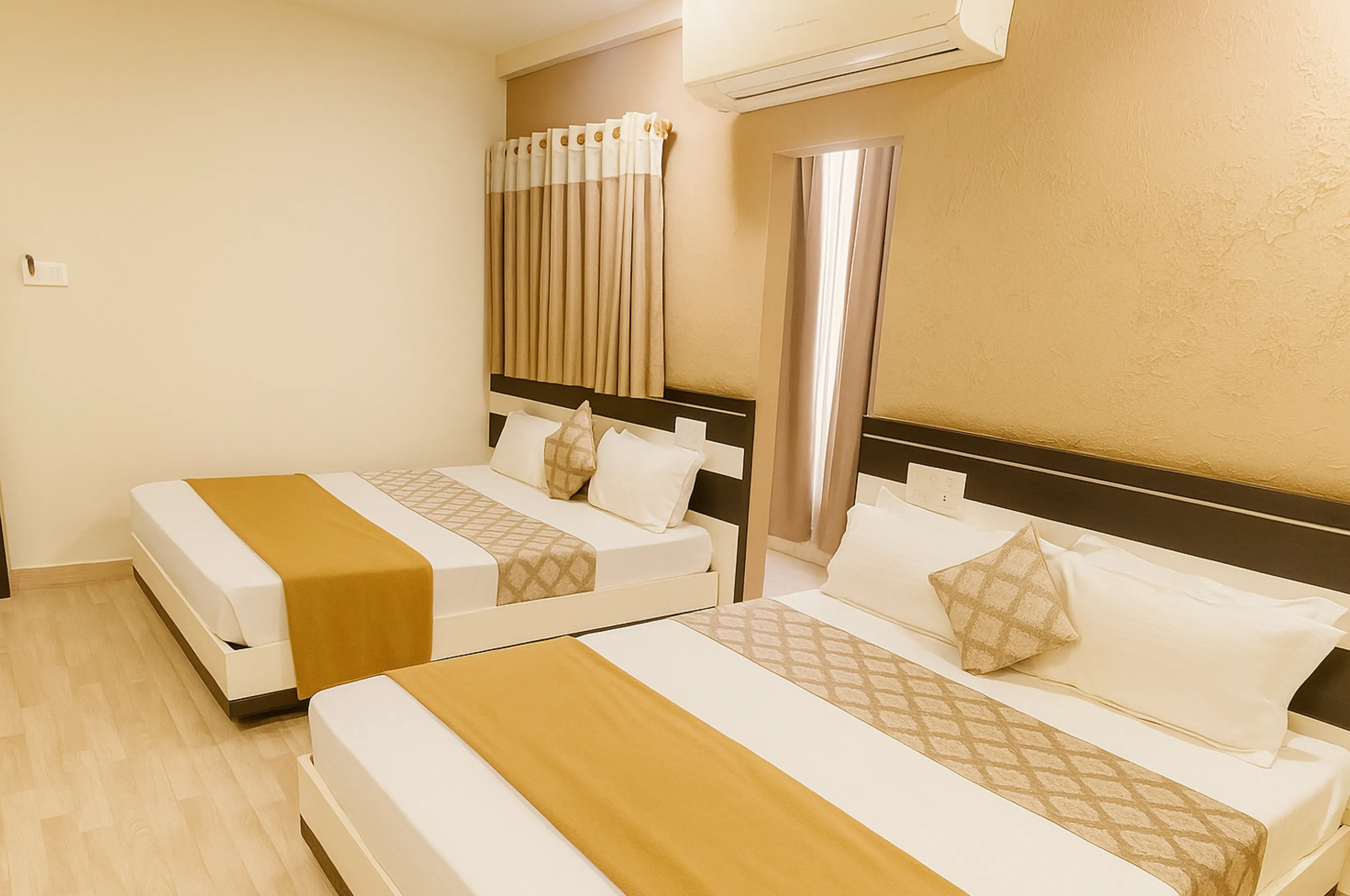 Comfortable four bed non AC room ideal for group stay at Hotel Vrajbhoomi Somnath.