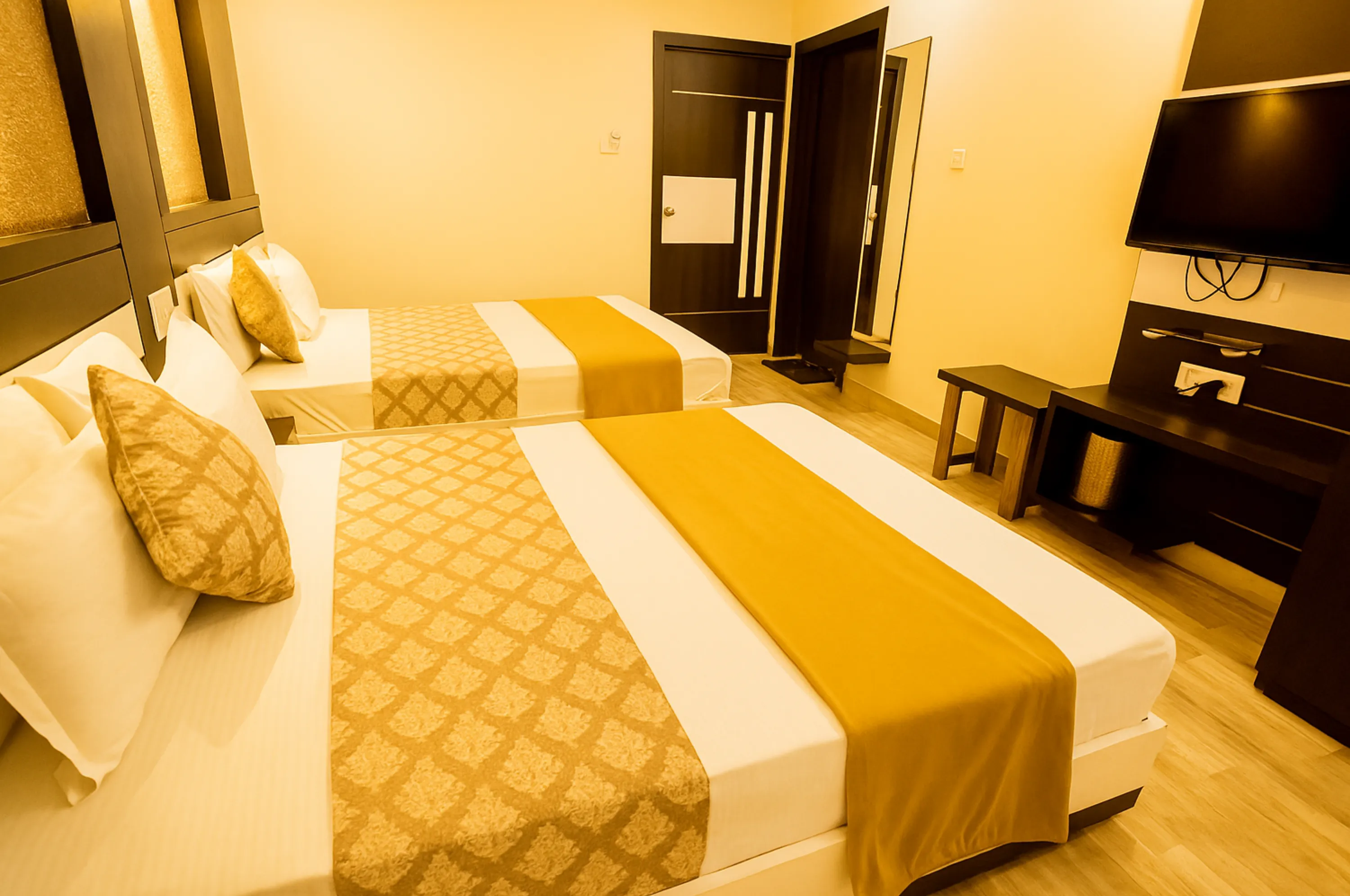 Four bed AC family room at Hotel Vrajbhoomi Somnath with spacious layout.