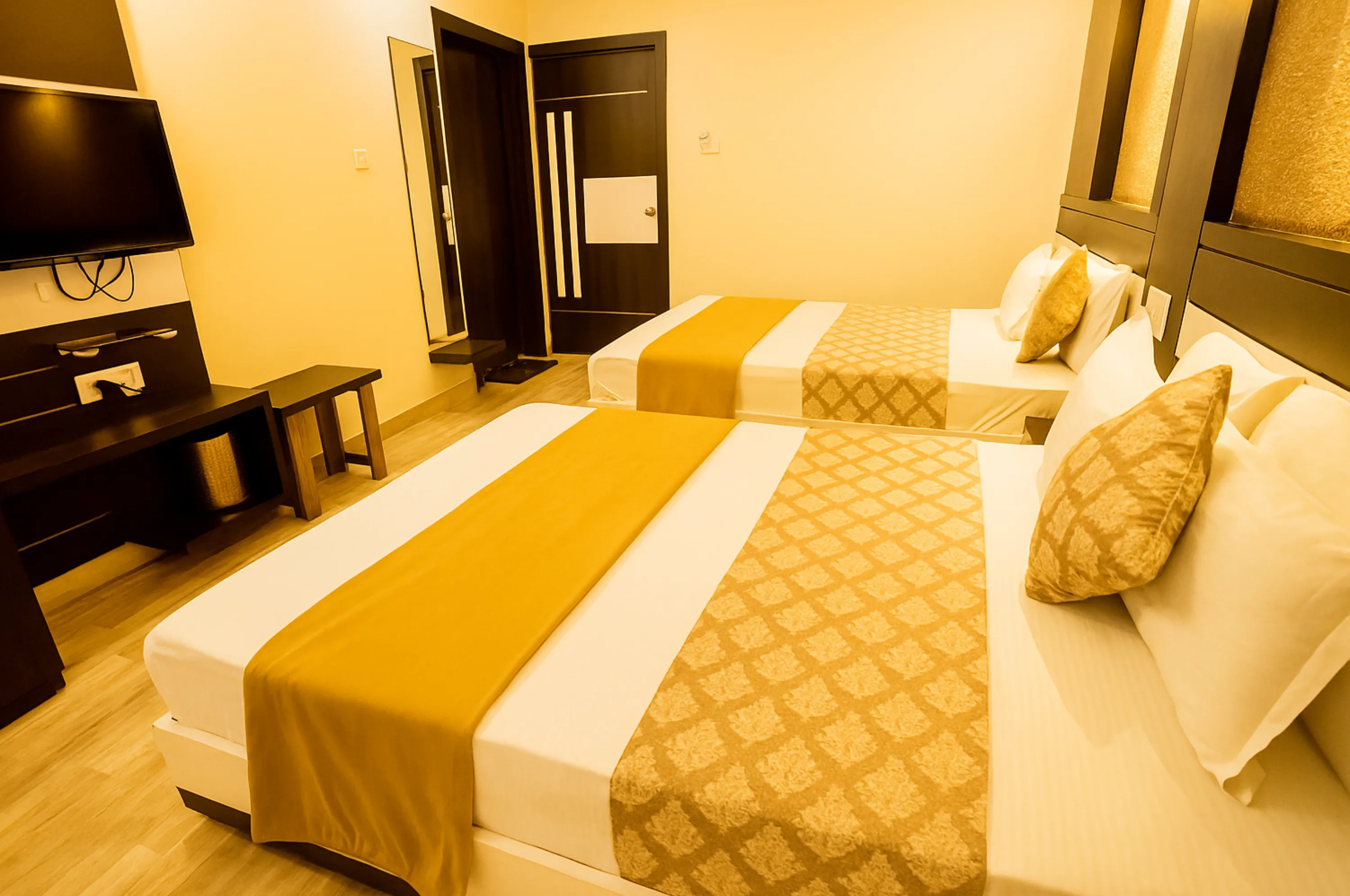 Four bed non AC family room at Hotel Vrajbhoomi Somnath with neat and cozy ambiance.