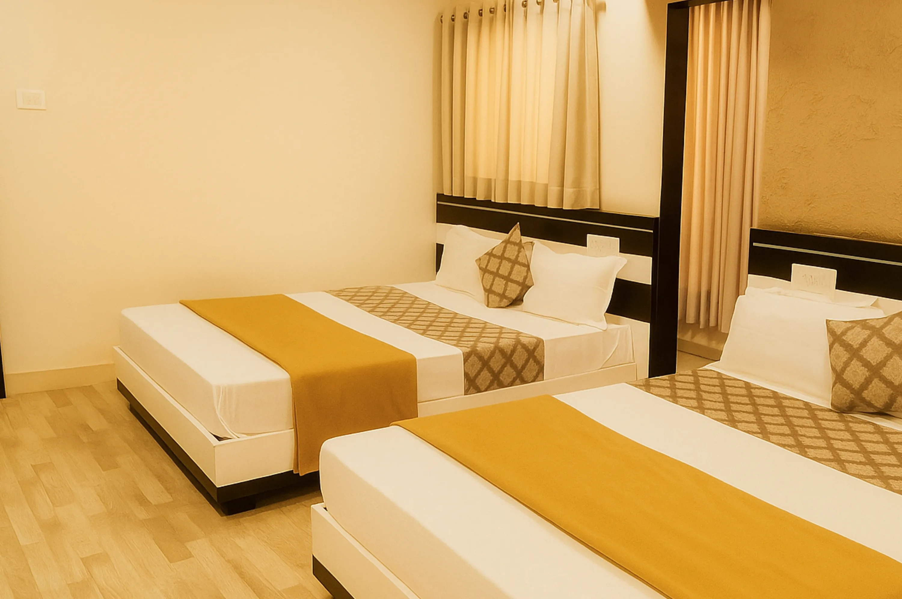 Four bed non AC room for families at Hotel Vrajbhoomi Somnath with comfort and space.
