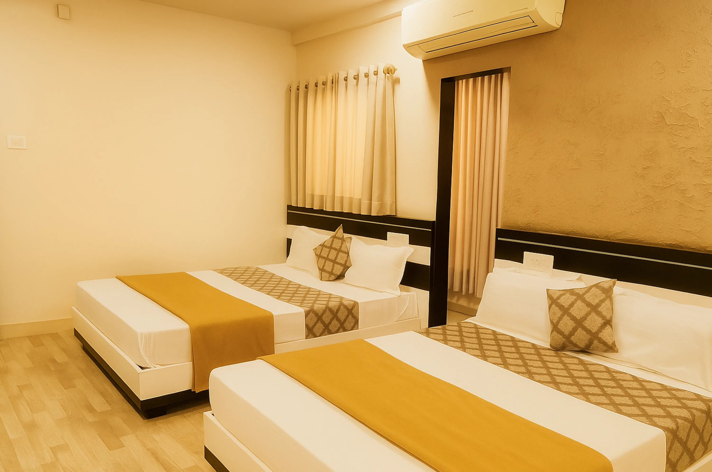 Group friendly four bed AC room at Hotel Vrajbhoomi Somnath ideal for large families.