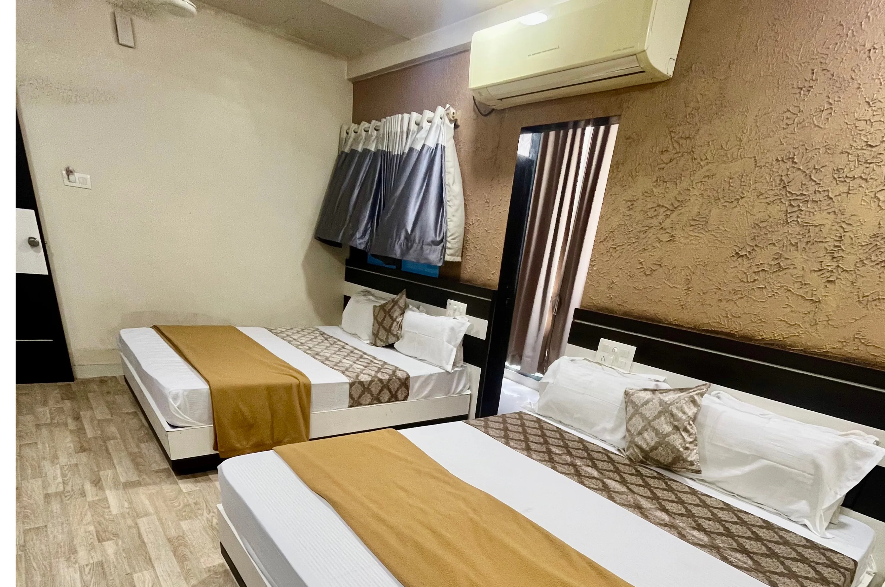 Large non AC four bed room for group stay at Hotel Vrajbhoomi Somnath.
