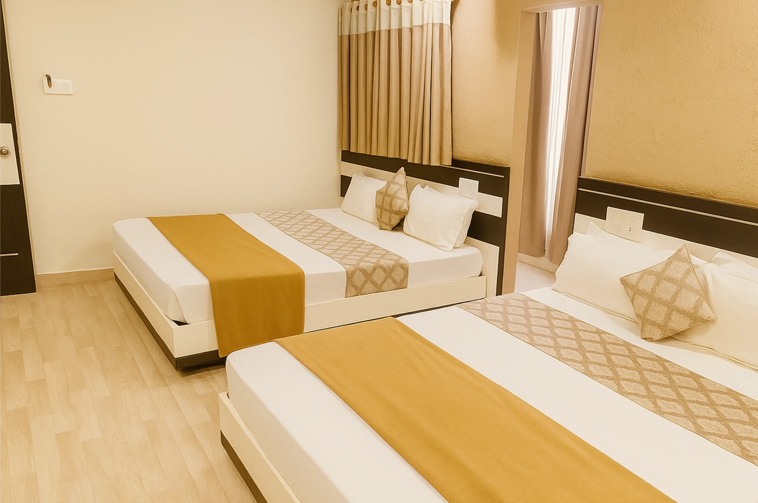Premium four bed AC room at Hotel Vrajbhoomi Somnath for luxury family stay.