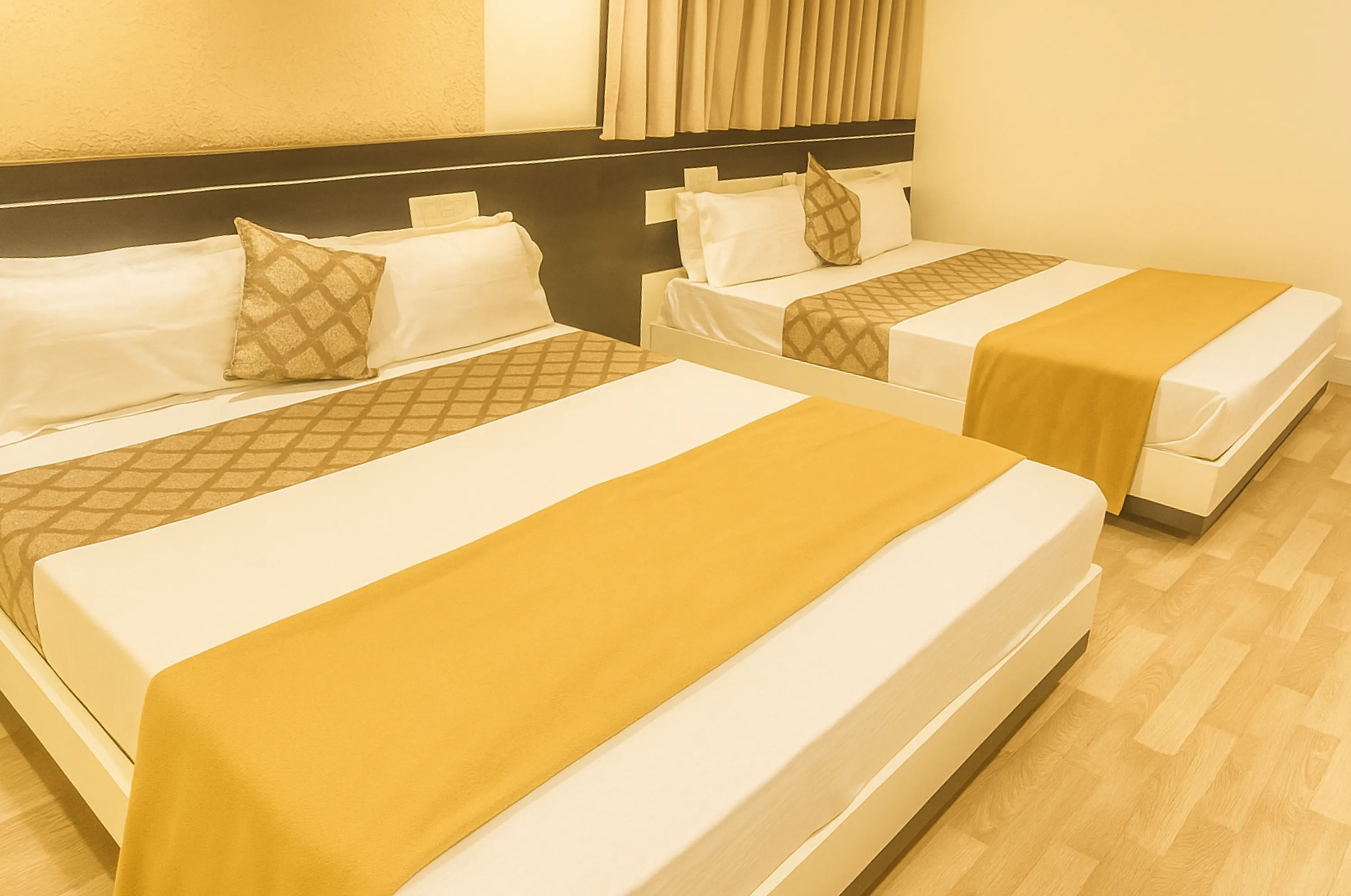 Spacious AC four bed family suite at Hotel Vrajbhoomi Somnath with premium comfort.