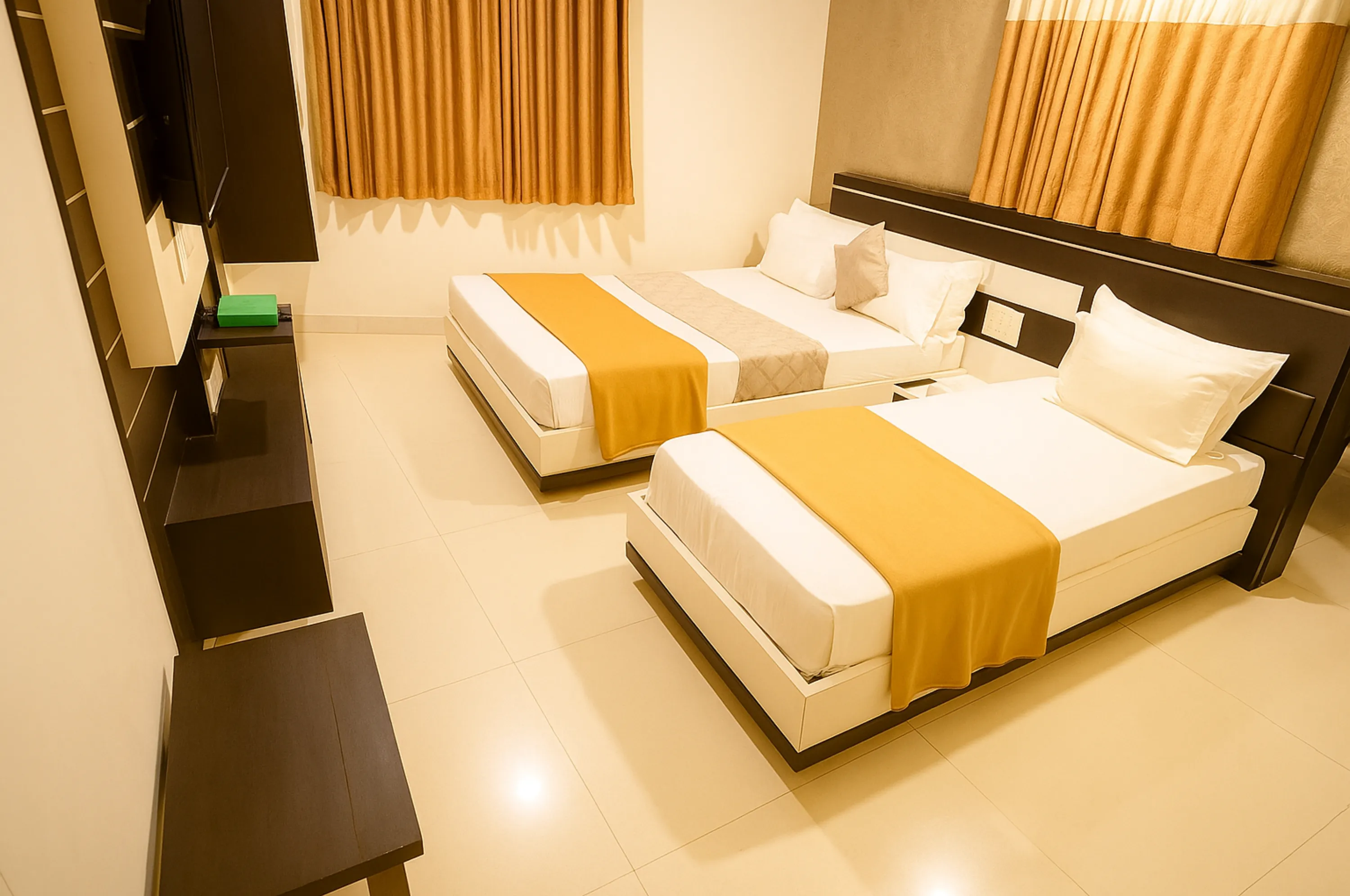 Modern triple bed room at Hotel Vrajbhoomi Somnath with cozy beds